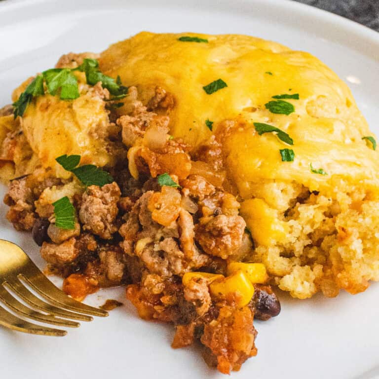 square image of a portion of skillet turkey cornbread casserole on a plate