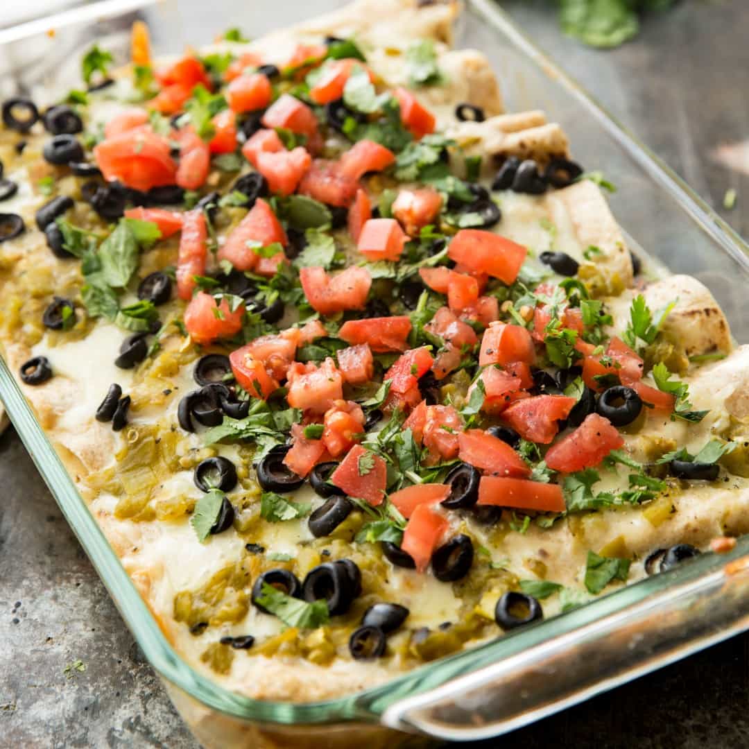 These Skinny Creamy Chicken Enchiladas are so full of flavor that no one will know that they're skinny! You can even make a double batch and freeze one for later. It's the perfect make-ahead family meal!