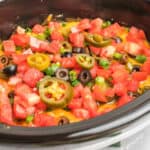 square image of slow cooker 7 layer chili cheese dip in a crock pot