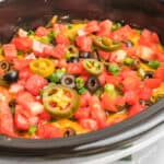 square image of slow cooker 7 layer chili cheese dip in a crock pot