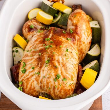 square image of slow cooker barbecue chicken and veggies in the crockpot