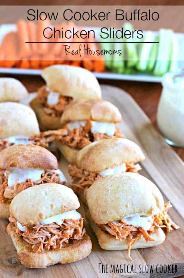 Slow Cooker Buffalo Chicken Sliders lined up on a serving board with carrots and celery