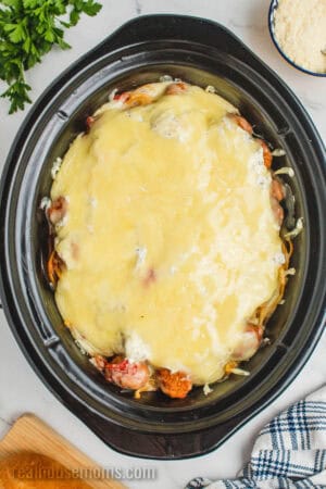 slow cooker cheesy spaghetti and meatballs after melted the mozzarella on top