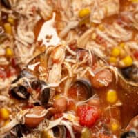 image of slow cooker chicken taco soup in a crock pot with recipe name at the bottom with thr title of the post on top of th eimage in blue and black lettering