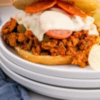 slow cooker pizza sloppy joes on a plate with recipe name at the bottom