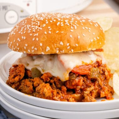 square image of slow cooker pizza sloppy joes on a plate with potato chips