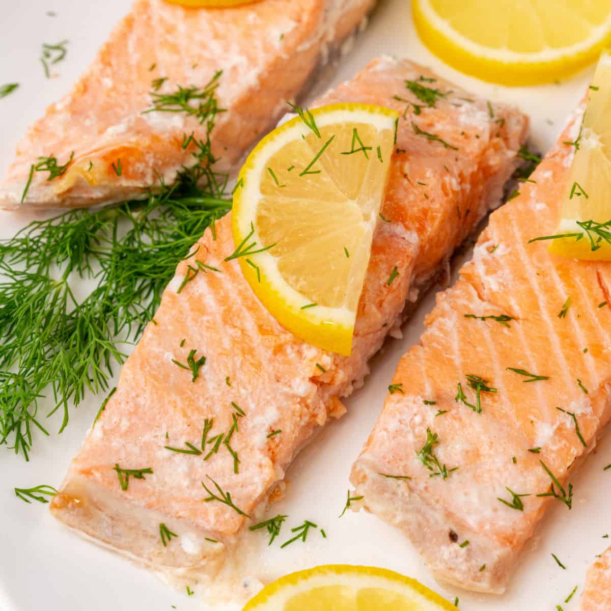 square image of slow cooker poached salmon on a platter