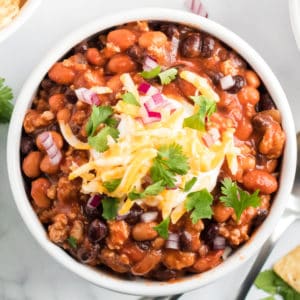 Slow Cooker Taco Chili is the ULTIMATE hearty comfort food. It's warm, meaty, and has a slight kick to keep you wanting more!