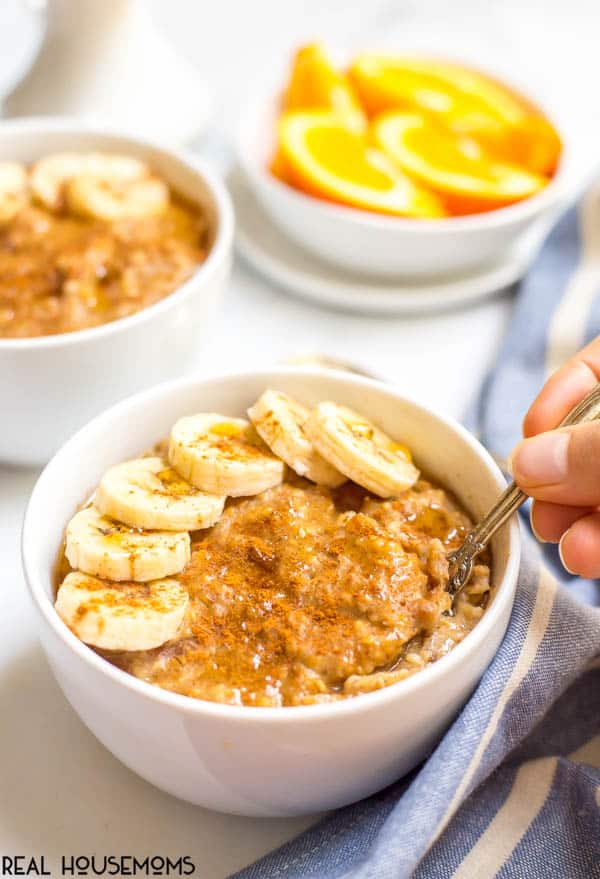 Spoon digging into a bowl of Slow Cooker Maple Cinnamon Oatmeal