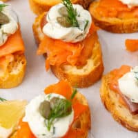 close up of smoked salmon crostini with recipe name at the bottom