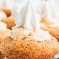 image of snickerdoodle pumpkin cheesecake bites on a wire rack with the title of the post on top of image with orange and black lettering