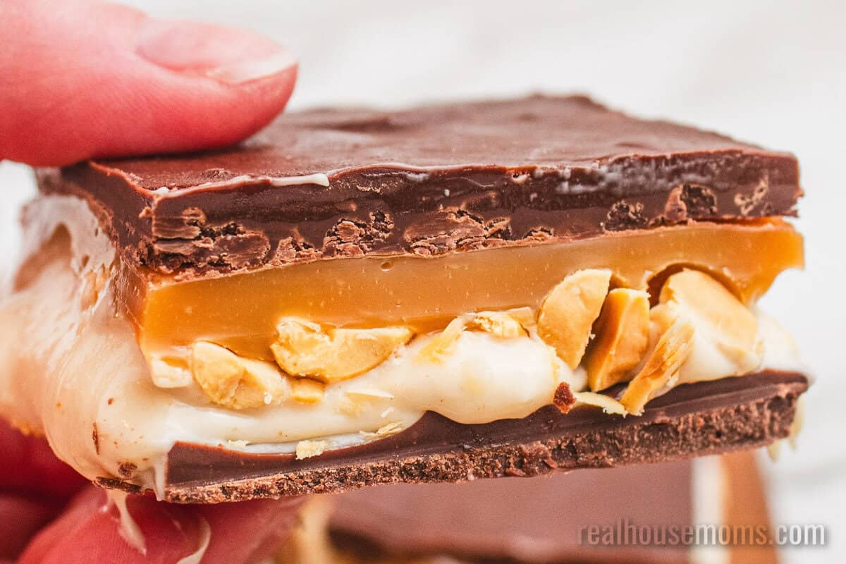 hand holding a snickers cheesecake bar
