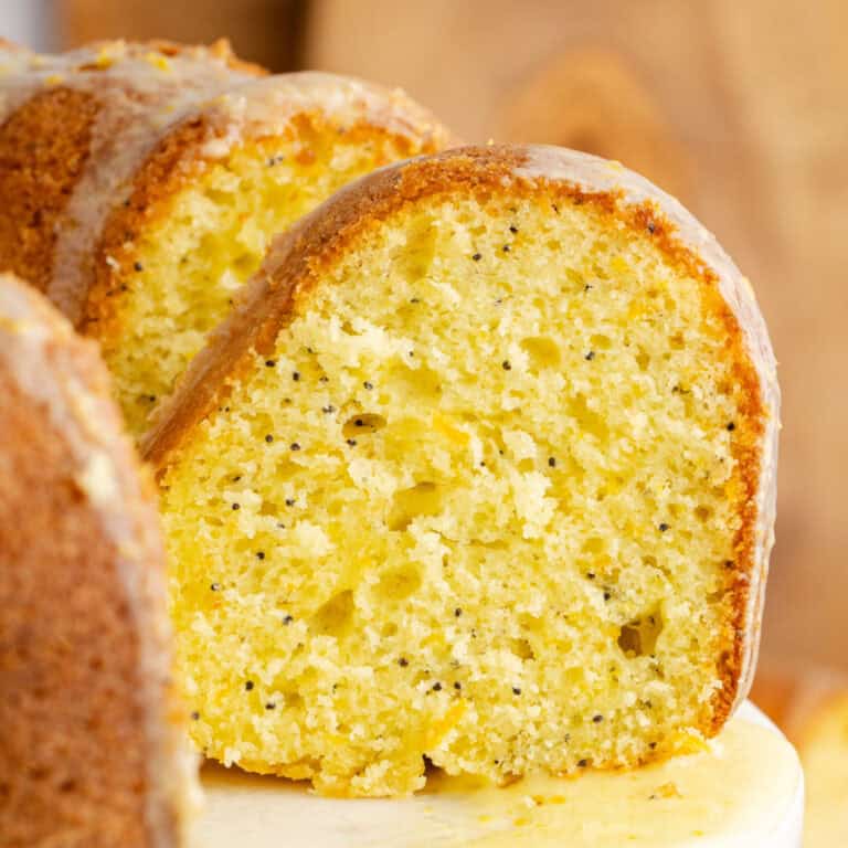 square image of the side view of sour cream orange cake slices cut from the cake