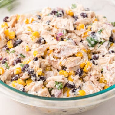 close up square image of southwest chicken salad in a glass bowl