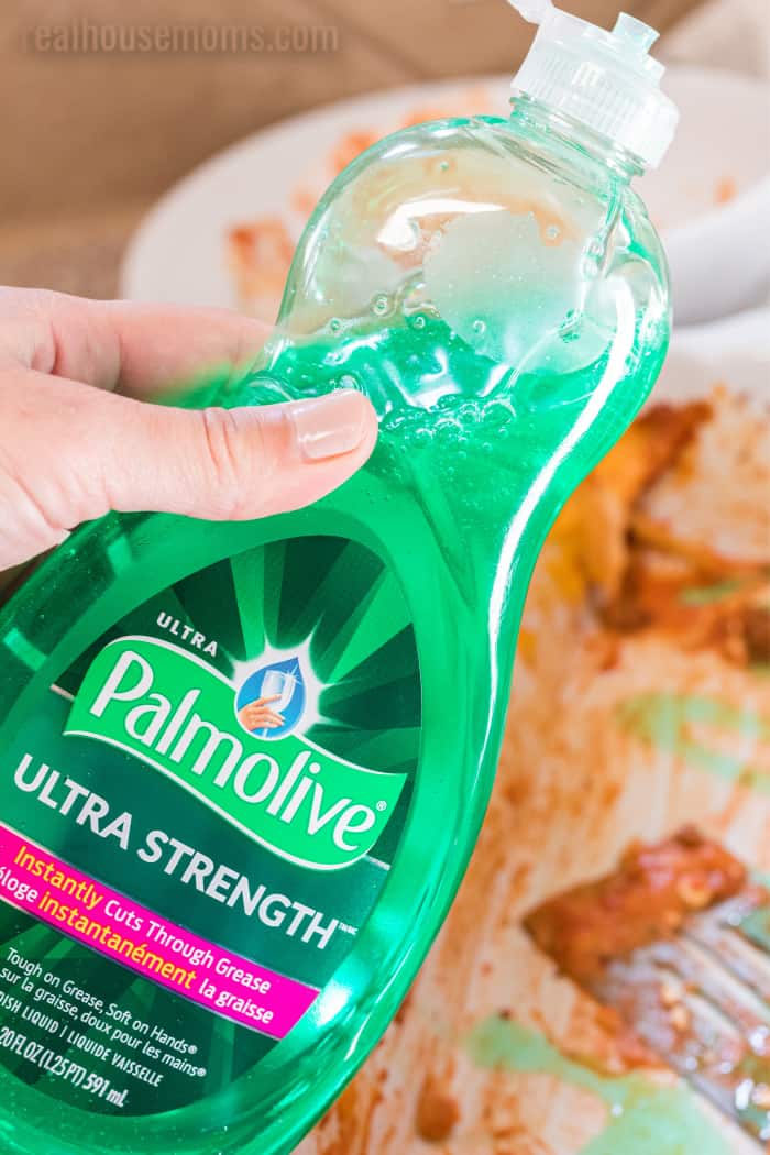palmolive bottle above dirty dishes
