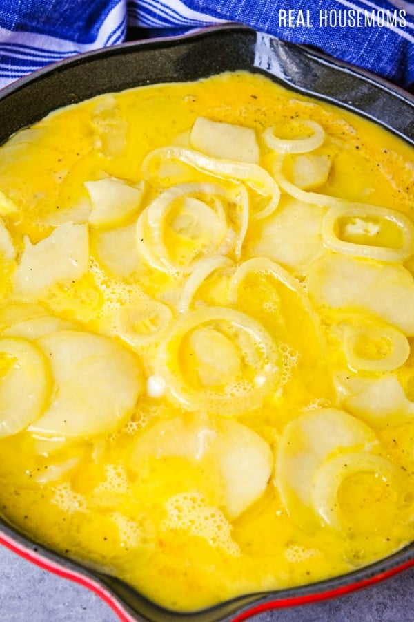 spanish tortilla ingredients in a skillet before cooking