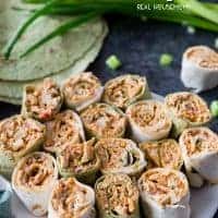 Spicy Chicken Tortilla Roll Ups are full of amazing flavors perfect for any party! These easy chicken pinwheels can be made ahead of time & served up later!
