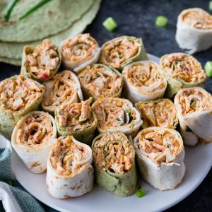 Spicy Chicken Tortilla Roll Ups are full of amazing flavors perfect for any party! These easy chicken pinwheels can be made ahead of time & served up later!