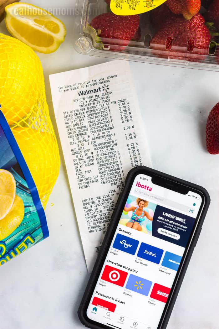 ibotta app on a smart phone laying on top of a Walmart shopping receipt