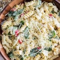 This Spinach Artichoke Pasta Salad is a fast and delicious pasta dish that can be assembled in a matter of moments and is sure to wow at your next potluck or party!