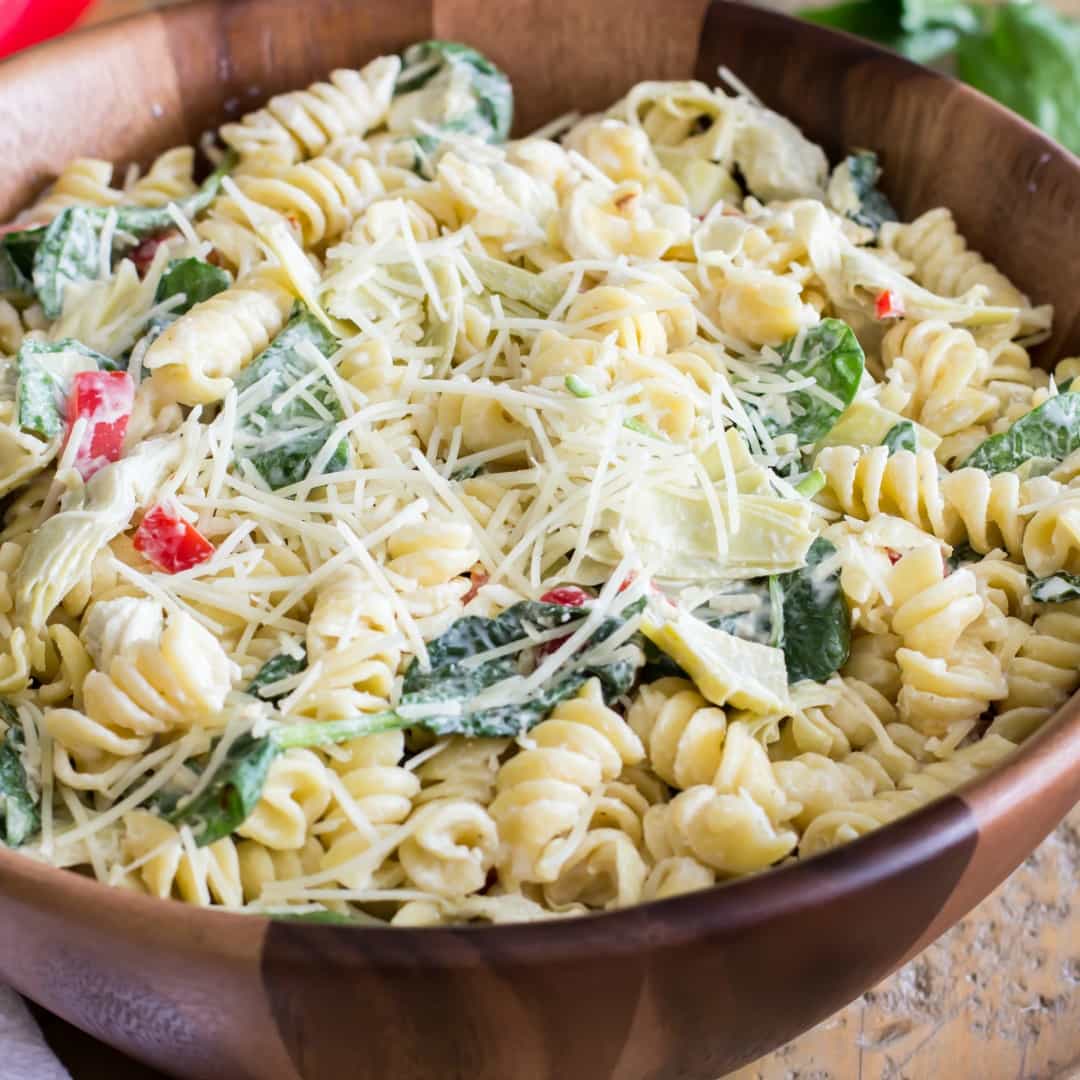 This Spinach Artichoke Pasta Salad is a fast and delicious pasta dish that can be assembled in a matter of moments and is sure to wow at your next potluck or party!