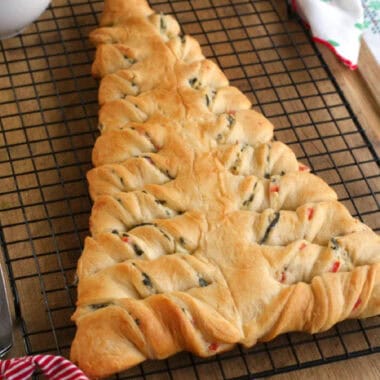 square image of a Spinach Dip Stuffed Crescent Roll Christmas Tree on a wire rack