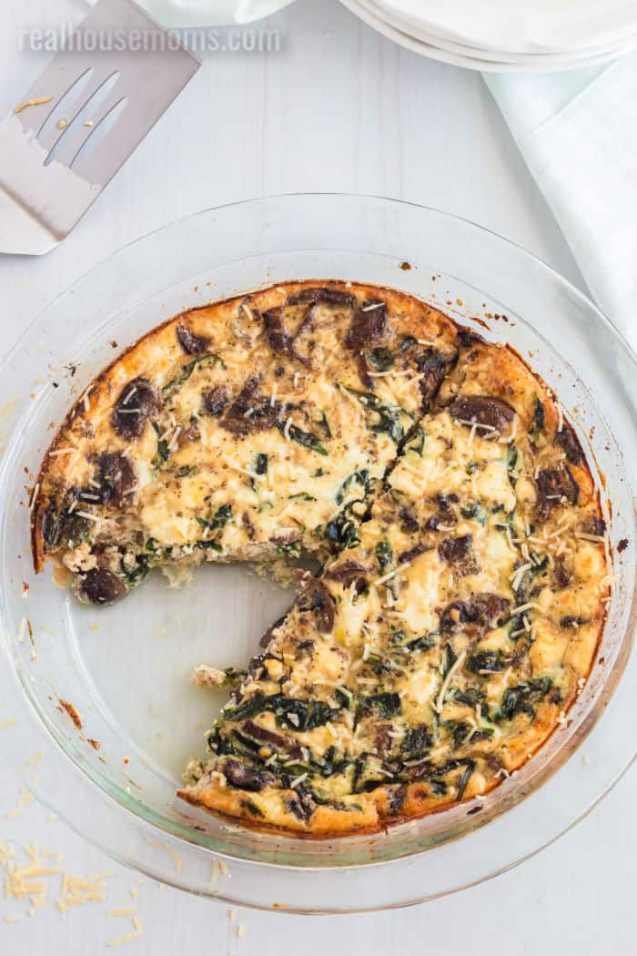 spinach mushroom quiche with a slice taken out