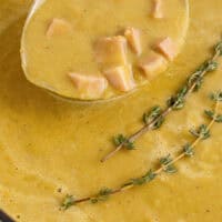 ladle of split pea soup over the post with recipe name at the bottom