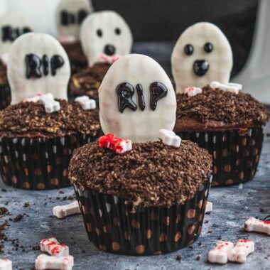 square image of spooky peanut butter filled chocolate cupcakes with tombstone and ghost decorations