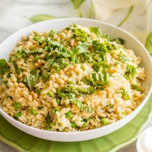 One-pot spring rice pilaf with asparagus and peas is a bright, fresh and easy side dish that’s topped with Parmesan cheese, fresh basil & pine nuts!