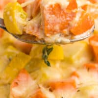 close up of squash sweet potato gratin with a spoonful in the middle of the image with blue and black writing on top of the image