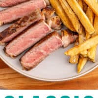 steak frites and a small bowl of ketchup on a plate with recipe name at the bottom