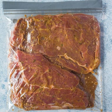 square image os steaks with steak marinade in a food storage bag
