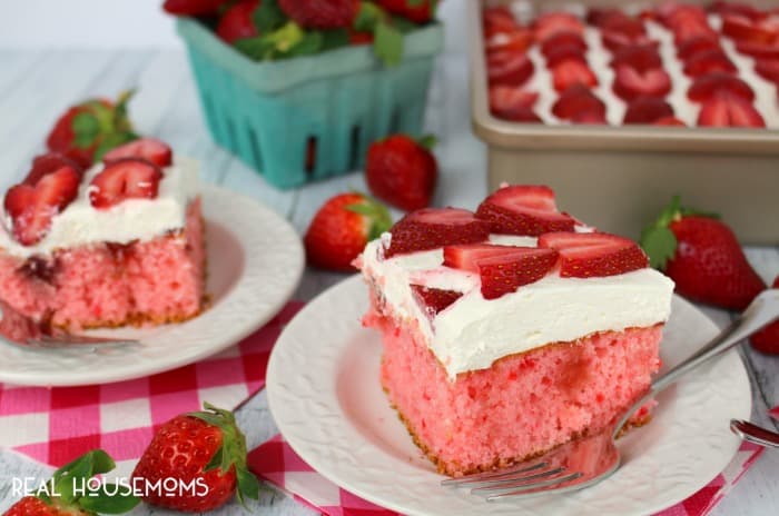 This STRAWBERRIES AND CREAM POKE CAKE is the most amazing strawberry cake, ever! Perfect anytime you're in the mood for a delicious berry dessert!