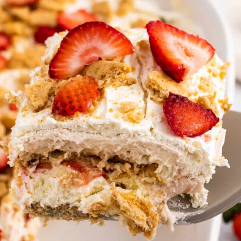 square image of a slice of strawberry cheesecake lasagna on a spatula