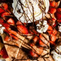 looking down at a plate of strawberry dessert nachos with recipe name at bottom