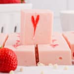 square image of a square of strawberry fudge on top of other squares
