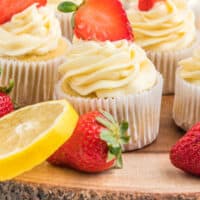 strawberry lemon cupcakes on a wood tray with recipe name at the bottom