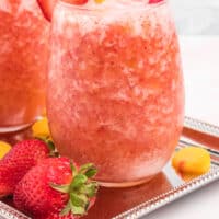 two glasses of strawberry peach frose with recipe name at the bottom