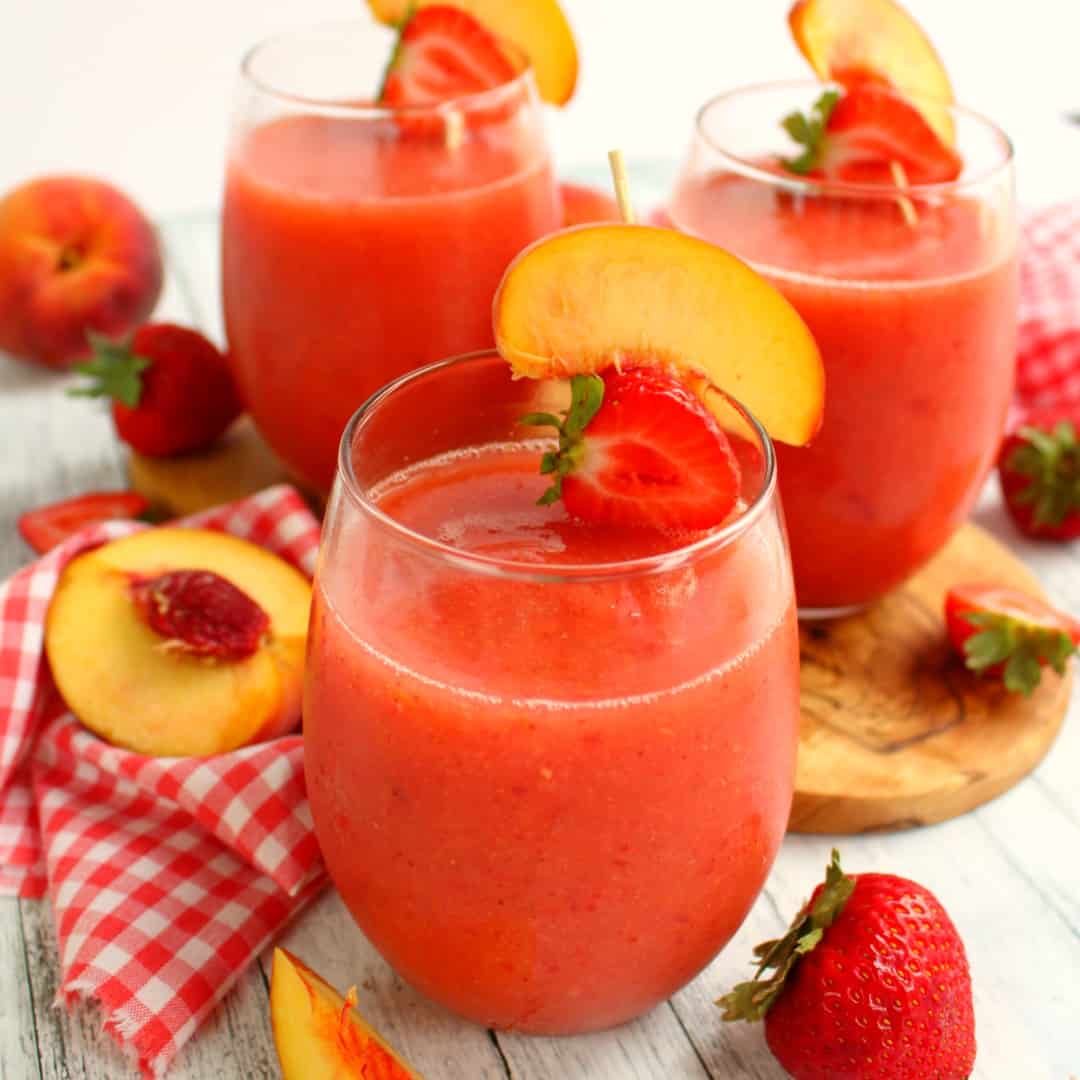 Strawberry Peach Frosé will be your new favorite cocktail! Made with rosé wine, this easy, blended drink is an amazing libation to share with friends on a warm summer night!