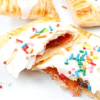 homemade strawberry pop tart broken in half to show filling with recipe name at bottom