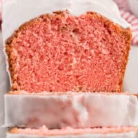 square image of loaf of strawberry pound cake with champagne glaze with slices cut to show inside