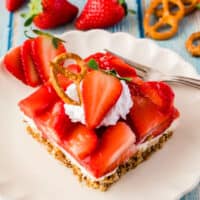 slice of strawberry pretzel salad on a plate with recipe name at the bottom