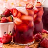 square image of two glasses of strawberry sweet tea next o a basket of strawberries