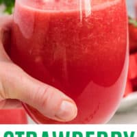 hand holding a glass of strawberry watermelon lemonade slushie with recipe name at bottom