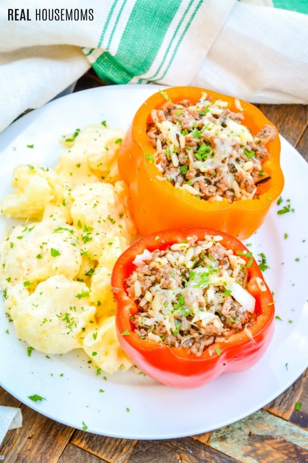 stuffed peppers served on a dinner plate with mashed potatoes