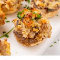 stuffed mushrooms arrange on a serving board with recipe name at the bottom