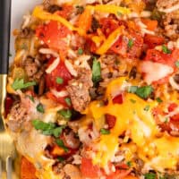 image portion of stuffed pepper casserole topped with chopped parsley on a plate with a fork with the title of the post on top of the image in blue and black lettering