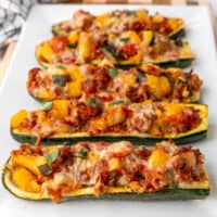 square image of stuffed zucchini boats on a platter