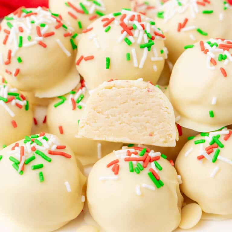square image of sugar cookie truffles on a plate with one cut in half